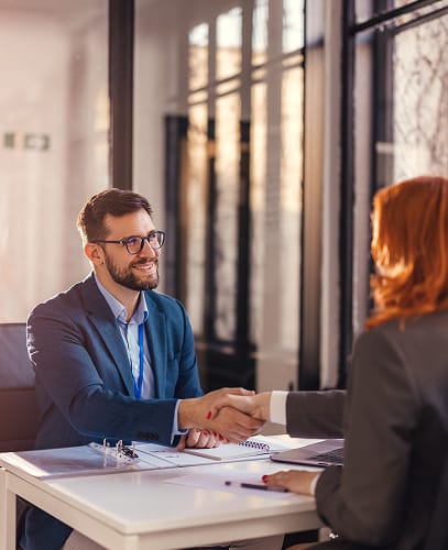 Two employees shaking hands
